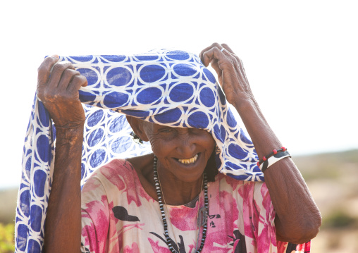 Old somali woman adjusting her hijab, Awdal region, Zeila, Somaliland