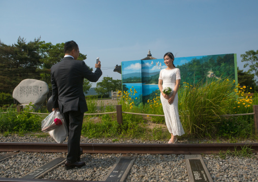 North korean defector joseph park taking a picture of his south korean fiancee juyeon on the north and south korea border, Sudogwon, Paju, South korea