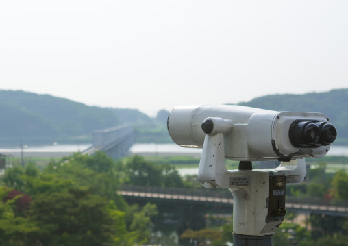 Binoculars in front of freedom and railway bridge over imjin river between north and south korea, Sudogwon, Paju, South korea