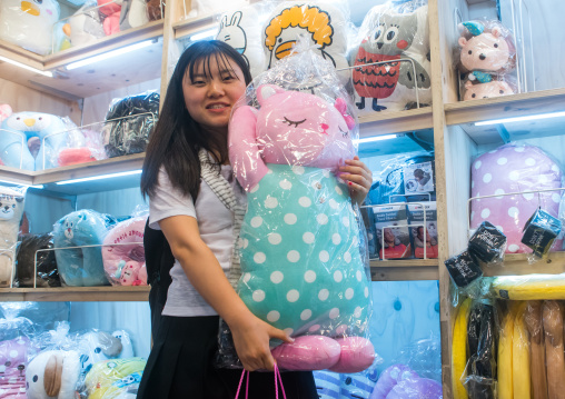 North korean teen defector buying a funny pillow, National capital area, Seoul, South korea
