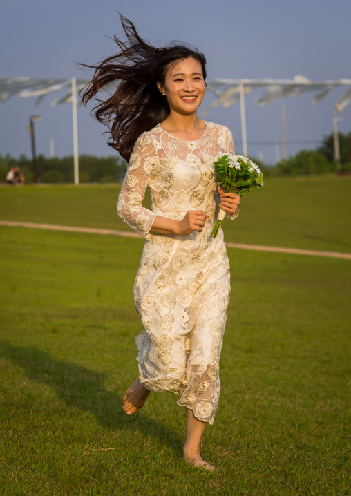 South korean woman called juyeon running in a wedding dress, Sudogwon, Paju, South korea