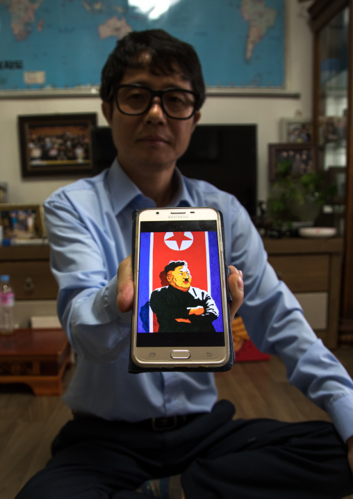 Former north Korea propaganda artist called Song Byeok showing a portrait of kim jong looking like Hitler, National Capital Area, Seoul, South Korea