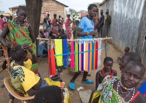 Toposa man selling beads to make necklaces in a market, Namorunyang State, Kapoeta, South Sudan
