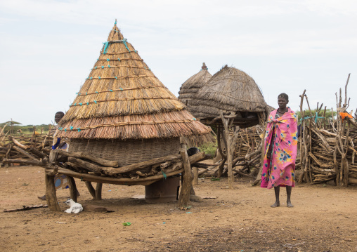 Toposa tribe woman standing near a granary in a village, Namorunyang State, Kapoeta, South Sudan