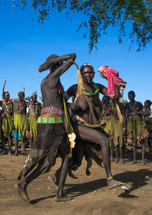 Toposa tribe women in traditional clothing dancing during a ceremony, Namorunyang State, Kapoeta, South Sudan