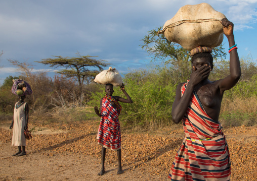 Larim tribe women carrying bags on their heads, Boya Mountains, Imatong, South Sudan