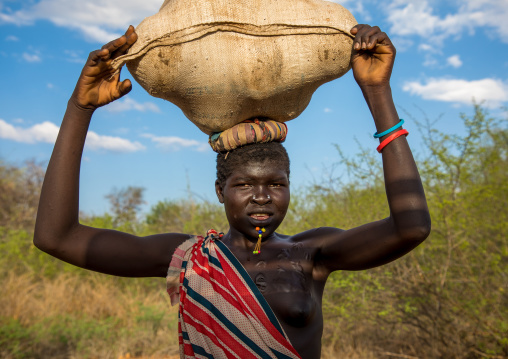 Larim tribe woman carrying a bag on her head, Boya Mountains, Imatong, South Sudan