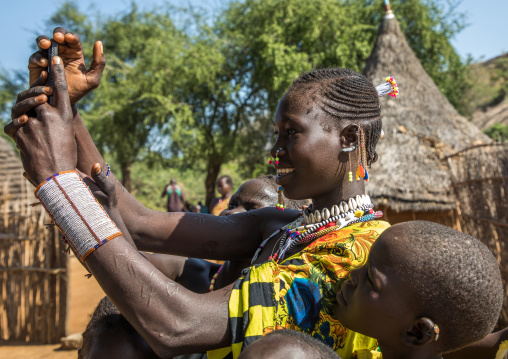 Smiling Larim tribe woman using a mobile phone, Boya Mountains, Imatong, South Sudan