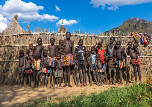 Larim tribe people standing in front of a fence in a village, Boya Mountains, Imatong, South Sudan