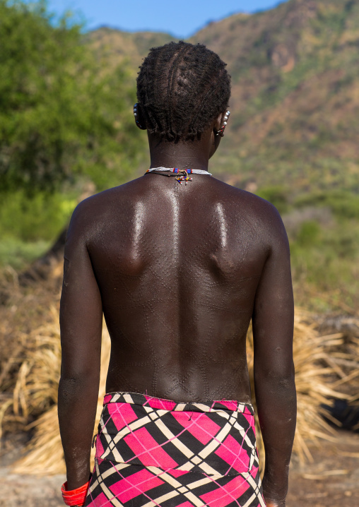 Portrait of a Larim tribe woman with scarifications on her body, Boya Mountains, Imatong, South Sudan