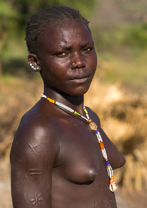 Portrait of a Larim tribe woman with scarifications on her body, Boya Mountains, Imatong, South Sudan