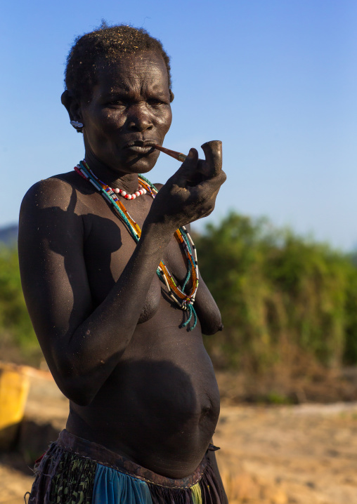 Larim senior tribe woman smoking pipe, Boya Mountains, Imatong, South Sudan
