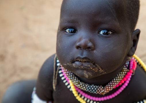 Larim tribe baby wearing necklaces, Boya Mountains, Imatong, South Sudan