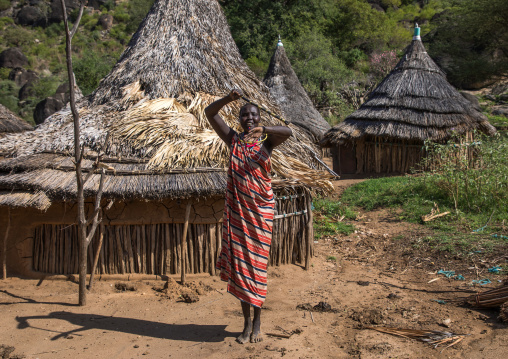 Larim tribe woman dancing with a traditional stick, Boya Mountains, Imatong, South Sudan