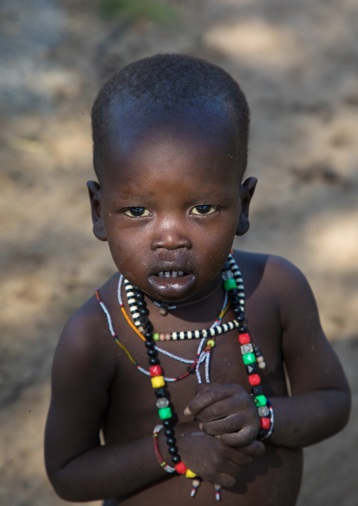 Portrait of a Toposa boy wearing necklaces, Boya Mountains, Imatong, South Sudan