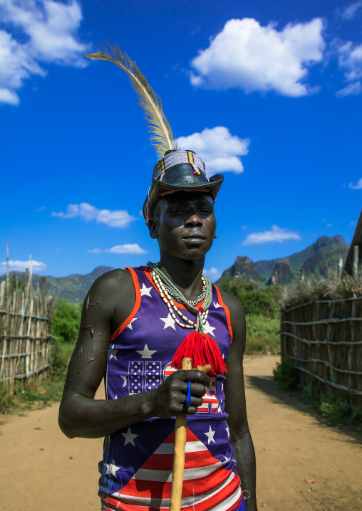 Larim tribe man with american tshirt and a hat, Boya Mountains, Imatong, South Sudan