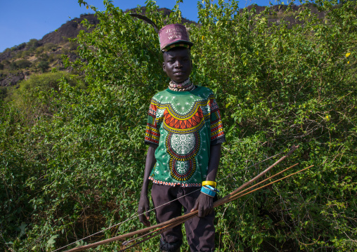Larim tribe boy with a bow dressed in a fashionable way, Boya Mountains, Imatong, South Sudan