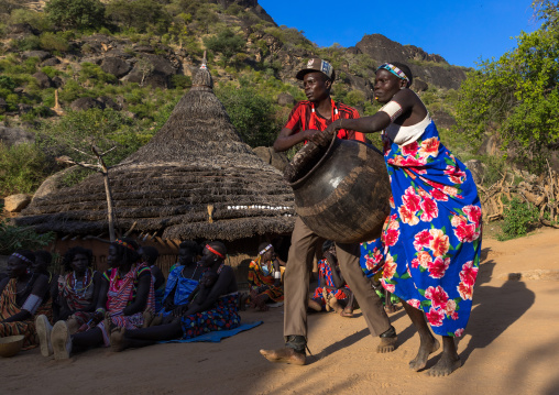 Larim tribe people carrying alcohol in a jar during a wedding ceremony, Boya Mountains, Imatong, South Sudan