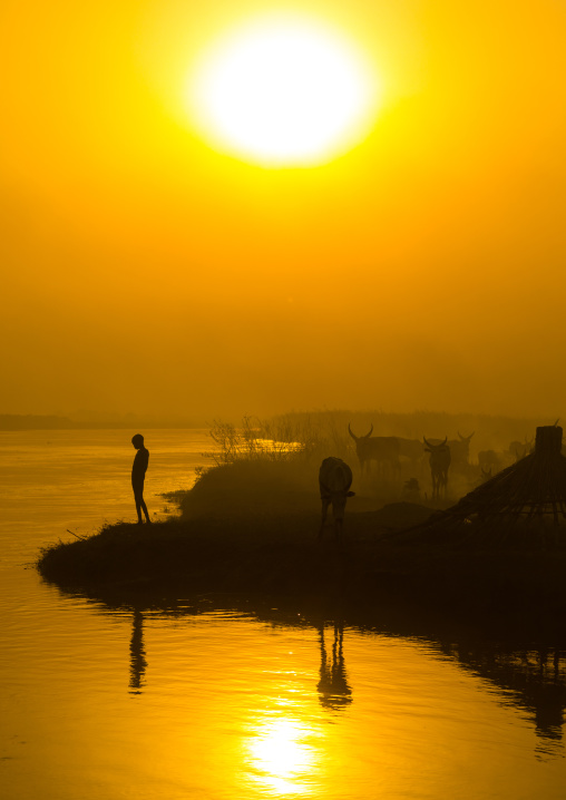 Mundari tribe child on the bank of river Nile at sunset, Central Equatoria, Terekeka, South Sudan