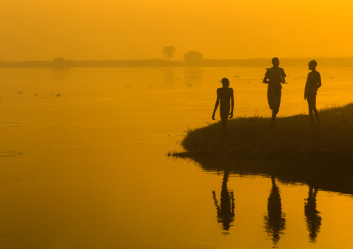 Mundari tribe people on the bank of river Nile at sunset, Central Equatoria, Terekeka, South Sudan