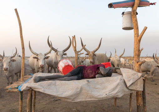 Mundari tribe boy resting on a bed in a cattle camp, Central Equatoria, Terekeka, South Sudan