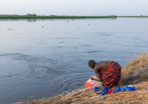 Mundari tribe women washing buckets in river Nile, Central Equatoria, Terekeka, South Sudan