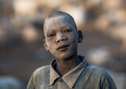 Portrait of a Mundari tribe boy covered in ash to repel flies and mosquitoes in a cattle camp, Central Equatoria, Terekeka, South Sudan