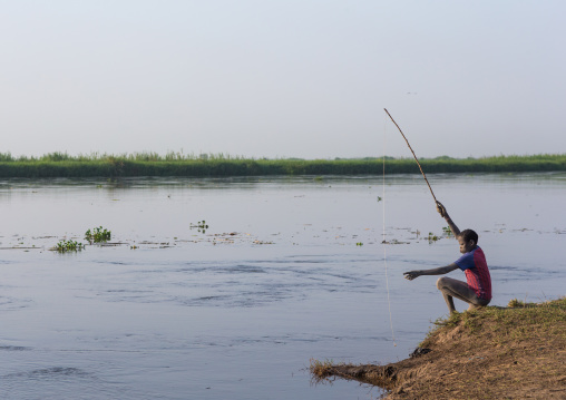 Mundari tribe boy fishing in river Nile, Central Equatoria, Terekeka, South Sudan