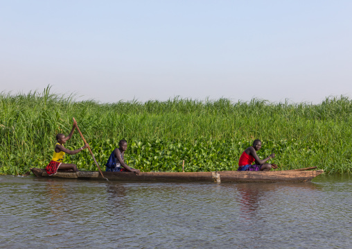 Mundari tribe women rowing in a boat on river Nile, Central Equatoria, Terekeka, South Sudan
