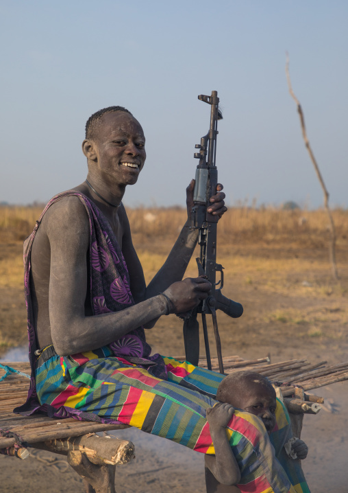 Mundari tribe man with a Kalashnikov in a cattle camp, Central Equatoria, Terekeka, South Sudan