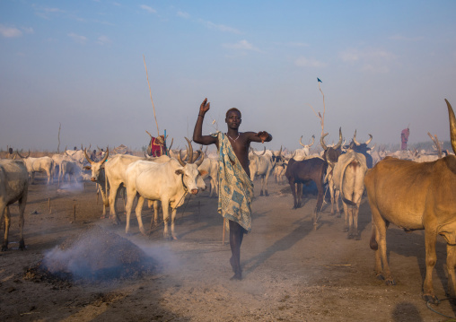 A Mundari tribe man mimics the position of horns of his favourite cow, Central Equatoria, Terekeka, South Sudan