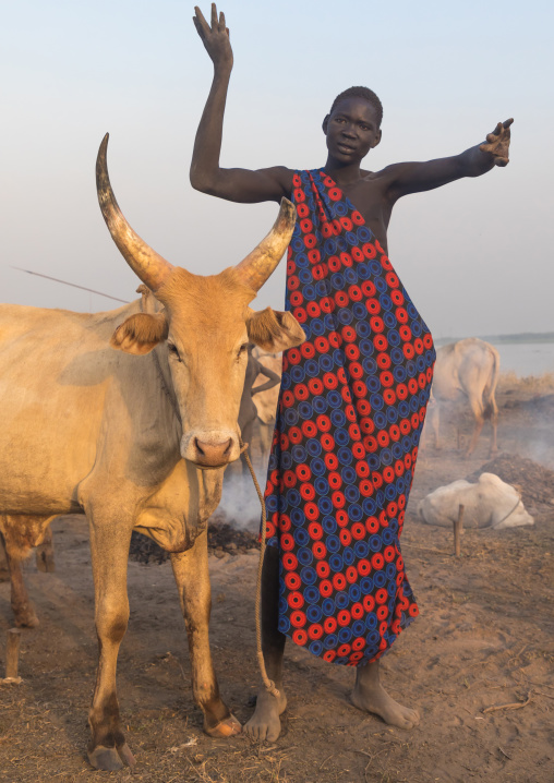 A Mundari tribe man mimics the position of horns of his favourite cow, Central Equatoria, Terekeka, South Sudan