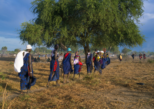 Mundari tribe women marching in line while celebrating a wedding, Central Equatoria, Terekeka, South Sudan