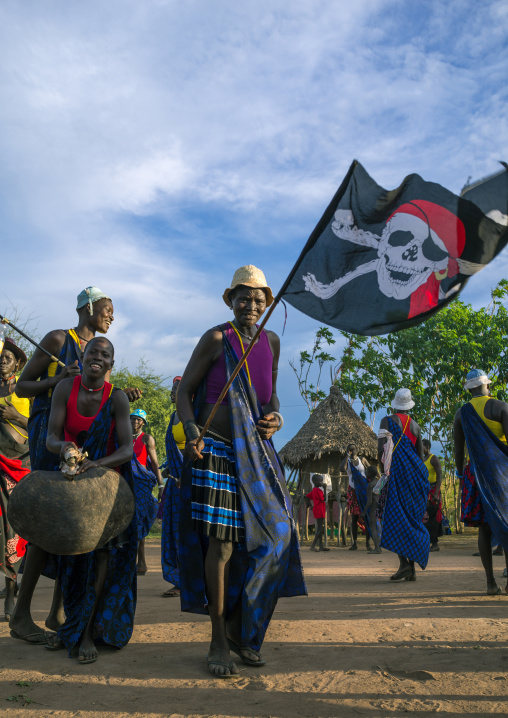 Mundari tribe women with a pirate flag while celebrating a wedding, Central Equatoria, Terekeka, South Sudan