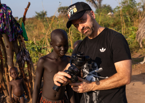 Tourist showing his picture to a Mundari girl, Central Equatoria, Terekeka, South Sudan