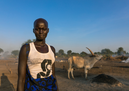 Mundari tribe women with her long horns cows in a camp, Central Equatoria, Terekeka, South Sudan