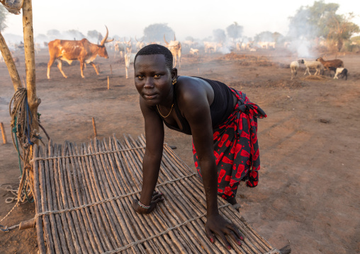 Mundari tribe woman near a bed in a long horns cows camp, Central Equatoria, Terekeka, South Sudan
