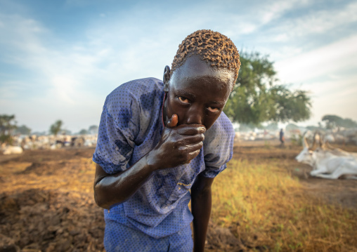 Mundari tribe boy showering with cow urine to take advantage of the antibacterial properties, Central Equatoria, Terekeka, South Sudan