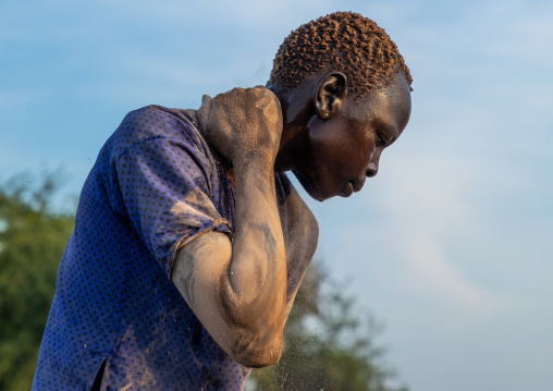 Mundari tribe man putting ash on his body after showering with cow urine, Central Equatoria, Terekeka, South Sudan
