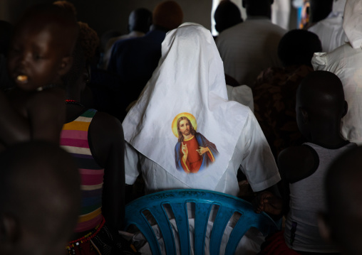 Mundari tribe nun with jesus christ on her veil during a sunday mass in a church, Central Equatoria, Terekeka, South Sudan