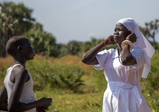 Mundari tribe nun putting her veil before a mass, Central Equatoria, Terekeka, South Sudan