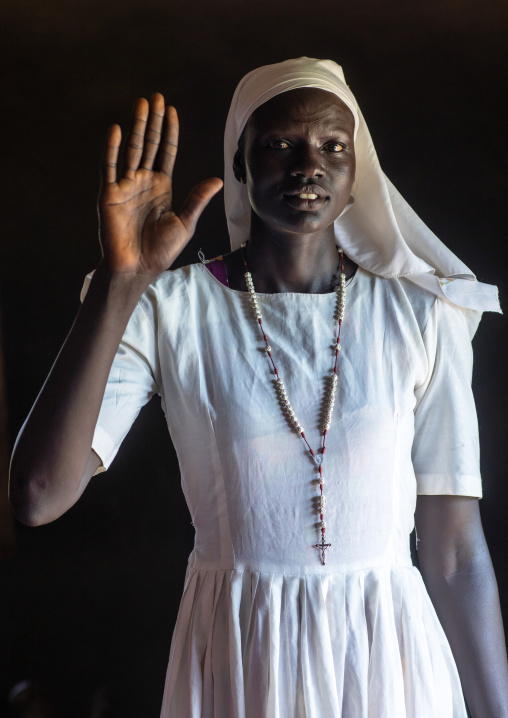 Portrait on a Mundari tribe nun with hand raised, Central Equatoria, Terekeka, South Sudan