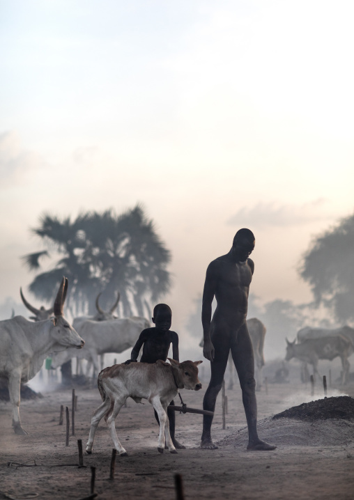 Mundari tribe people in the smoke of the bonfires used to repel the mosquitoes, Central Equatoria, Terekeka, South Sudan