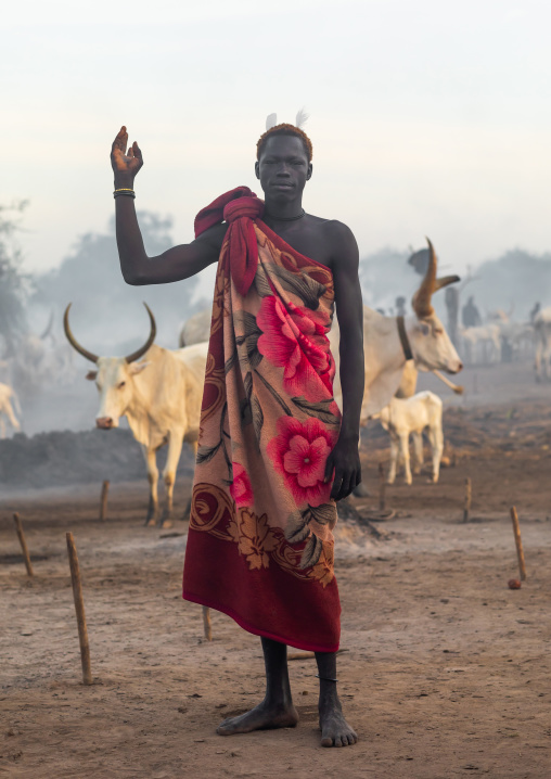 A Mundari tribe man mimics the position of horns of his favourite cow, Central Equatoria, Terekeka, South Sudan