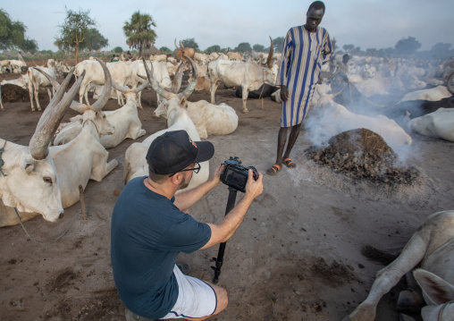 Tourist taking pictures in a Mundari tribe camp, Central Equatoria, Terekeka, South Sudan