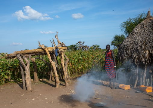 Mundari tribe woman standing in front of her house, Central Equatoria, Terekeka, South Sudan