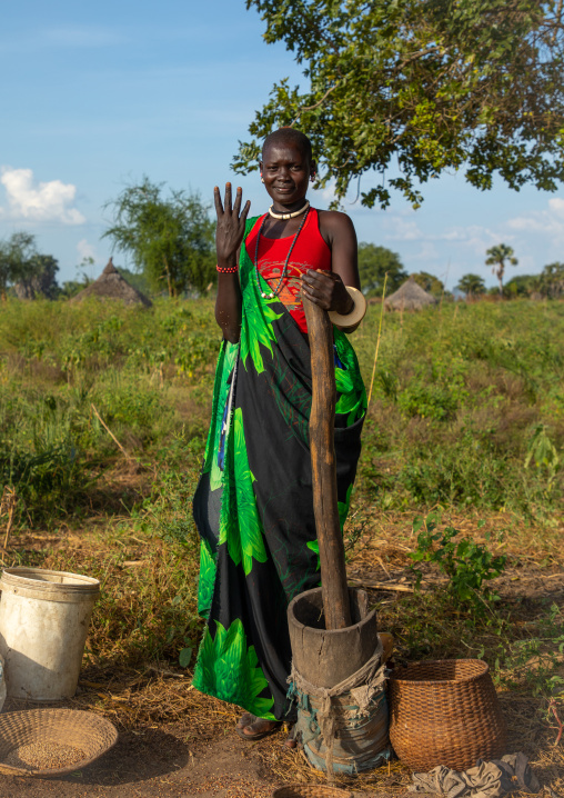 Portrait of a Mundari tribe woman using a pestle, Central Equatoria, Terekeka, South Sudan