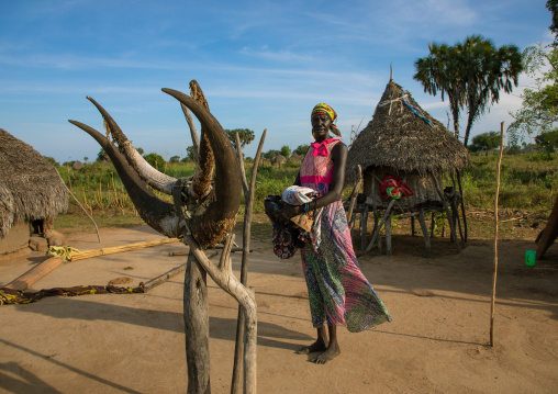 Mundari tribe woman standing in front of a totem made of cow horns, Central Equatoria, Terekeka, South Sudan
