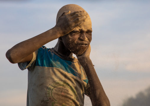 Mundari tribe boy covering his face in ash to protect from the mosquitoes and flies bites, Central Equatoria, Terekeka, South Sudan