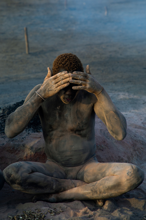 Mundari tribe man covering his body in ash to repel flies and mosquitoes, Central Equatoria, Terekeka, South Sudan